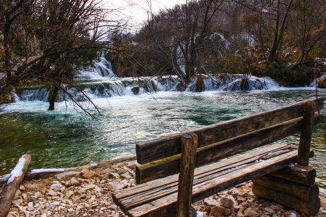 a lonely bench in plitvice national park, in croatia in winter